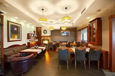 a restaurant with a dining room with tables and chairs at Kraljevi Cardaci, Kopaonik, Lux apartman 9C-71 in Kopaonik