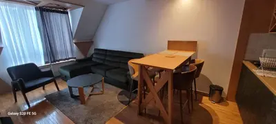 a living room with a table and a couch at Kraljevi Cardaci, Kopaonik, Lux apartman 9C-71 in Kopaonik