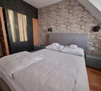 a bedroom with a bed with two towels on it at Kraljevi Cardaci, Kopaonik, Lux apartman 9C-71 in Kopaonik