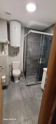 a bathroom with a toilet and a glass shower at Kraljevi Cardaci, Kopaonik, Lux apartman 9C-71 in Kopaonik