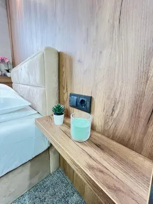 a wooden table with two plants on it next to a bed at R2 KOP Konaci in Kopaonik