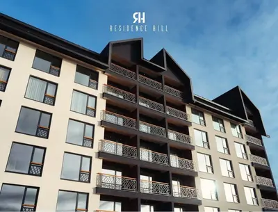 an apartment building with a black roof at Sophie & Sarah Apartments - Residence Hill, Kopaonik in Kopaonik