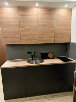 a kitchen with a sink and wooden cabinets at Sophie & Sarah Apartments - Residence Hill, Kopaonik in Kopaonik