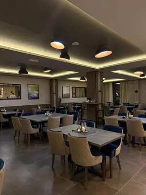 a dining room with tables and chairs at Sophie & Sarah Apartments - Residence Hill, Kopaonik in Kopaonik