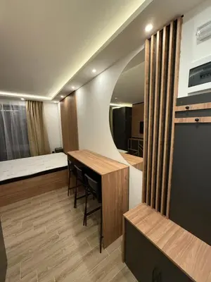 a room with a table and a bed and a mirror at Sophie & Sarah Apartments - Residence Hill, Kopaonik in Kopaonik