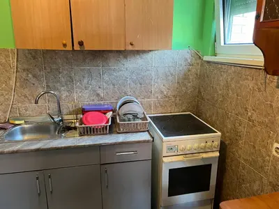 a small kitchen with a sink and a stove at Slobo Velickovic in Čerkeška Mala