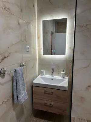 a bathroom with a sink and a mirror at NOMAD Studio in Niš