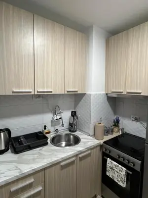a kitchen with a sink and a stove at NOMAD Studio in Niš