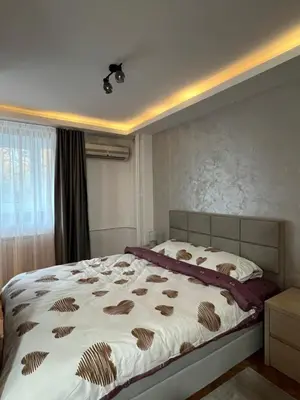 a bedroom with a large bed in a room at NOMAD Studio in Niš
