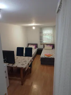 a living room with a table and a couch at Sobe za izdavanje Nedeljković in Lukovo