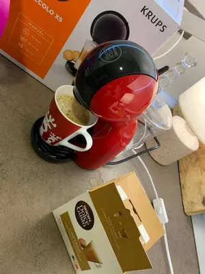 a coffee maker sitting next to a cup of coffee at Sofija lux in Jagodina