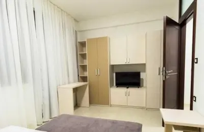 a room with a room with a tv and a room with at Sofija lux in Jagodina