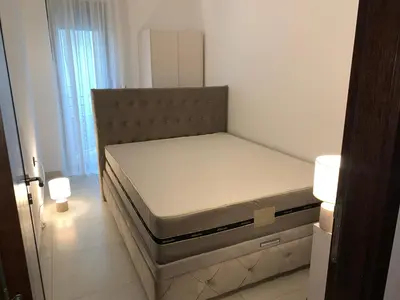 a bed in a white room with a mattress at Sofija lux in Jagodina