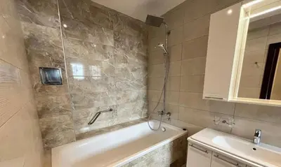 a bathroom with a bath tub and a sink at Sofija lux in Jagodina