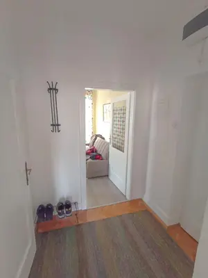 a hallway with a living room with a couch at Fontana in Kruševac