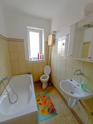 a bathroom with a tub and a toilet and a sink at Fontana in Kruševac