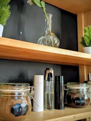 a wooden shelf with jars and a vase on it at Kopaonička priča in Kopaonik