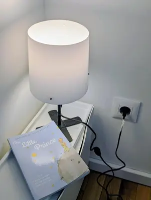 a lamp on a table with a book on it at Kopaonička priča in Kopaonik
