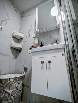 a white bathroom with a sink and a toilet at Kopaonička priča in Kopaonik