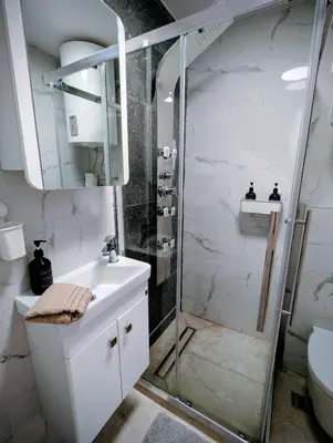 a bathroom with a shower and a sink and a toilet at Kopaonička priča in Kopaonik