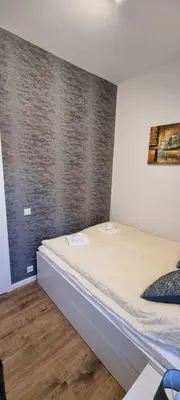 a bedroom with a bed in a room at Apartman Magic house in Kruševac
