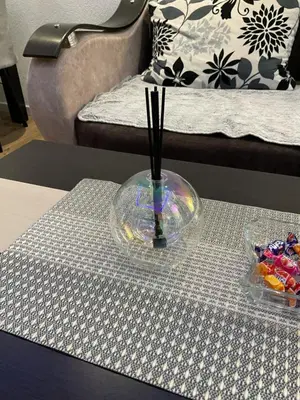 a glass vase sitting on top of a table at Apartman Magic house in Kruševac