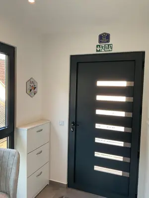 a black door with a sign on top of it at Apartman Magic house in Kruševac