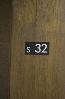 a wooden door with a sign that says on it at Apartman S32 Milmari in Raška