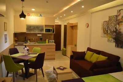 a living room with a couch and a table at Apartman S32 Milmari in Raška