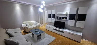 a living room with a couch and a television at Centar ljubavi in Kruševac