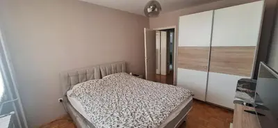 a bedroom with a bed and a large closet at Centar ljubavi in Kruševac