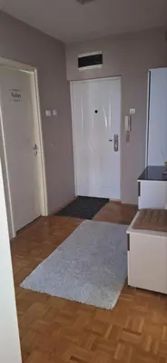 an empty room with a door and a white rug at Centar ljubavi in Kruševac