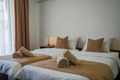 two beds sitting next to each other in a room at Attache Vila in Kruševac