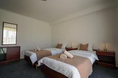 a bedroom with two beds and a window at Attache Vila in Kruševac