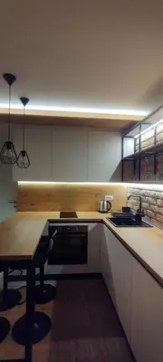 a kitchen with a table and a stove top oven at Apartman David in Vrnjačka Banja