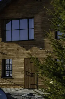 a building with a wooden door and windows at Chalet 1600 Kopaonik in Kopaonik
