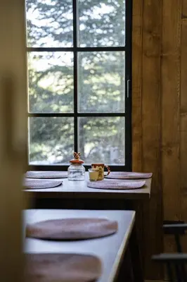 a kitchen with a window and a counter with a table at Chalet 1600 Kopaonik in Kopaonik