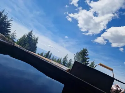a pool of water with the sky in the background at Chalet 1600 Kopaonik in Kopaonik