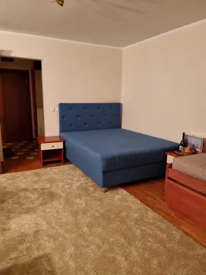 a bedroom with a blue bed in a room at Apartman Vrh,Kopaonik in Kopaonik