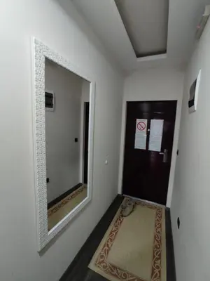 a hallway with a mirror next to a door at Apartman K25 Milmari in Kopaonik