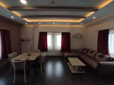 a living room with a couch and a table at Apartman K25 Milmari in Kopaonik