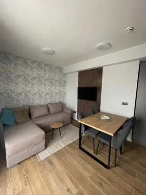 a living room with a couch and a table at Boggi Apartman, Kopaonik in Kopaonik