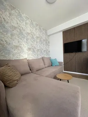 a living room with a couch and a flat screen tv at Boggi Apartman, Kopaonik in Kopaonik
