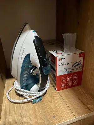 a hair dryer sitting on a table next to a box at Apartman KVINS in Kruševac
