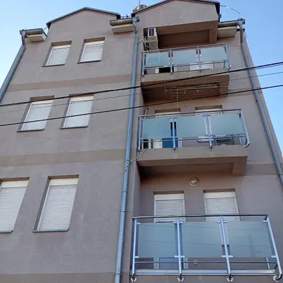 a tall building with balconies on the side of it at Apartman KVINS in Kruševac