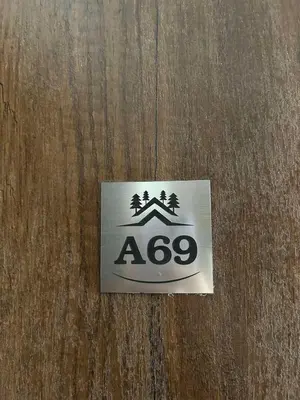 a sign on a wooden door with a sign at Apartman Snow Heaven Kopaonik in Kopaonik