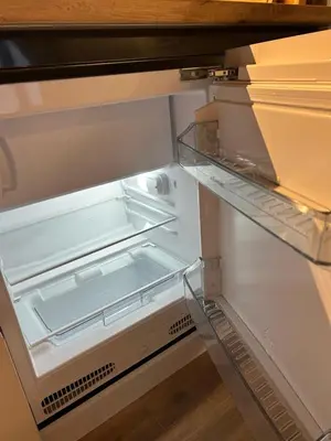 an empty refrigerator with its door open at Apartman Snow Heaven Kopaonik in Kopaonik