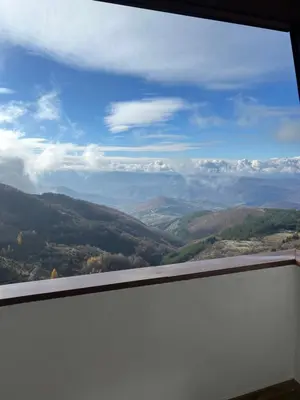 a view from a window of a mountain valley at Apartman Snow Heaven Kopaonik in Kopaonik