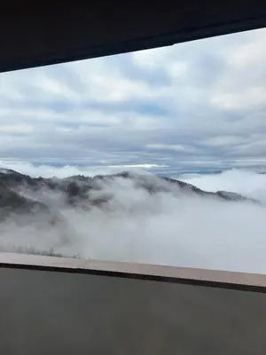 a view from a window of a foggy valley at Apartman Snow Heaven Kopaonik in Kopaonik