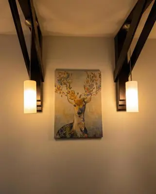 a painting of a deer on a wall with lights at Nomakop5 in Kopaonik